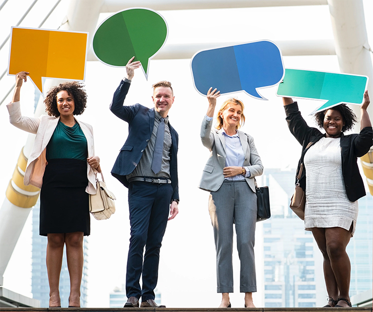 three woman and a man holding different social message icons