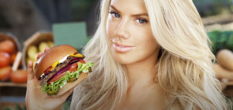 beautiful lady holding burger in hand